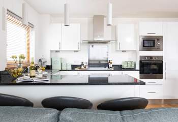 The well-equipped kitchen has a handy breakfast bar.