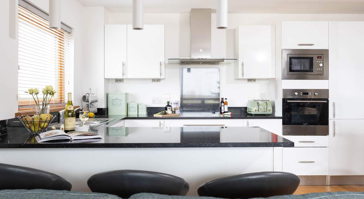 The well equipped kitchen has a handy breakfast bar.