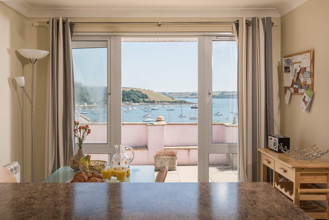 There is a breakfast table in the kitchen, keep your designated chef company.