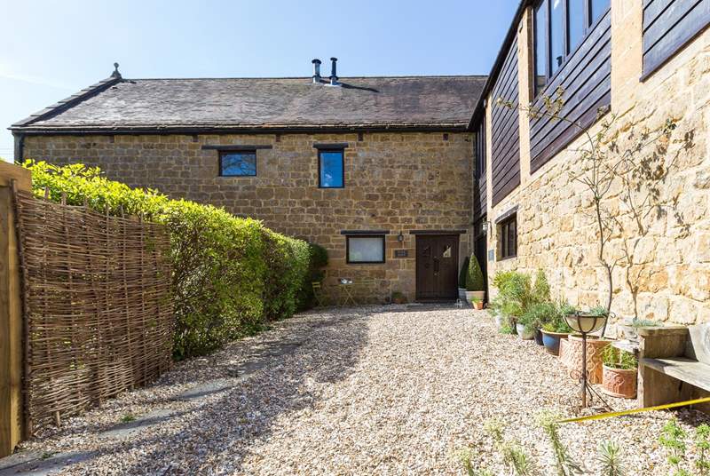 Flax Barn is this corner property in the historic Priory Barns development of traditional stone buildings. There is private parking for you.