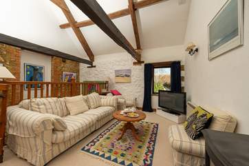The open plan first floor has high ceilings and beams giving this space plenty of character.