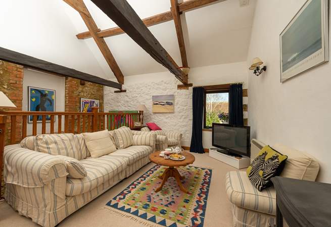 The open plan first floor has high ceilings and beams giving this space plenty of character.