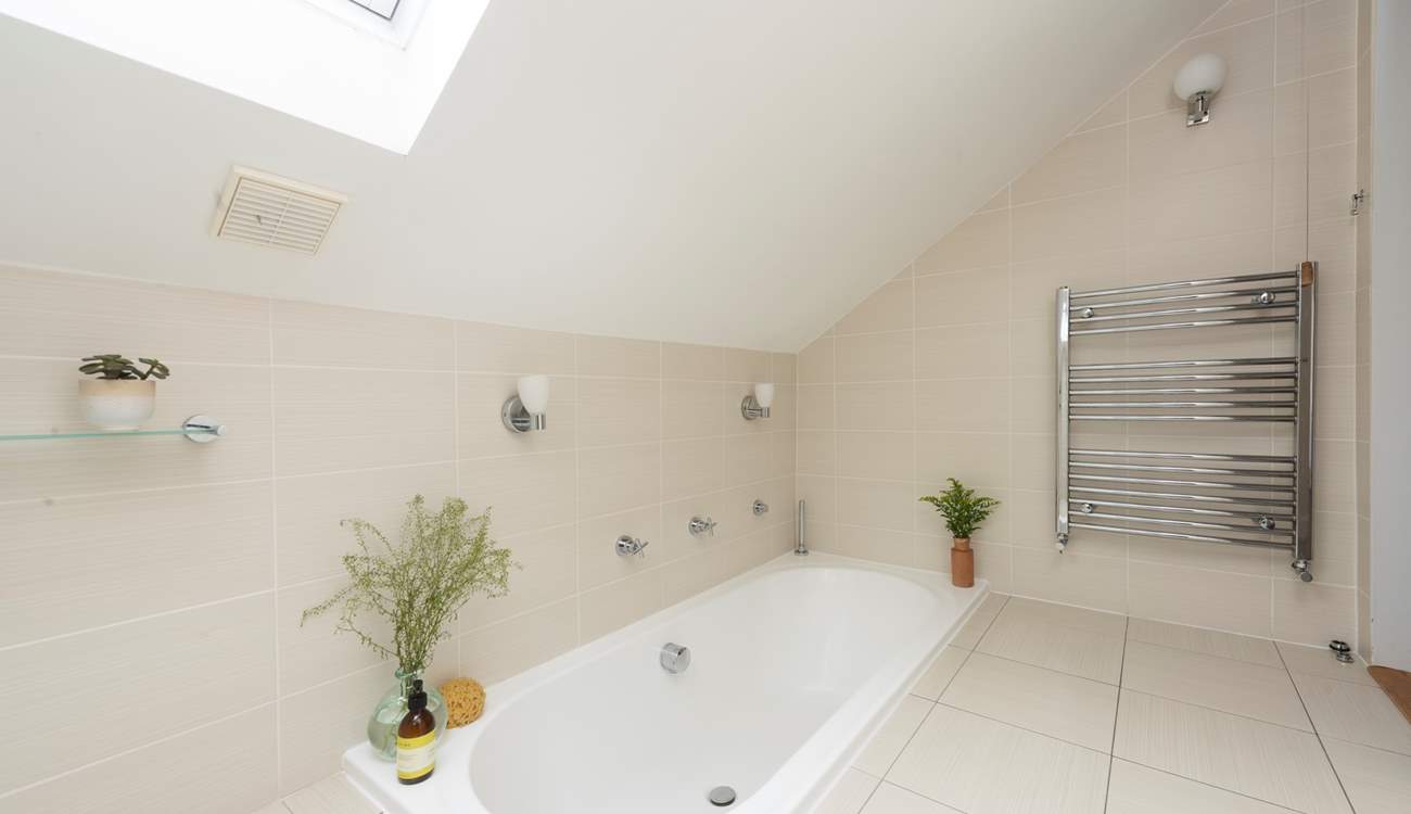 The upstairs bathroom has a sunken bath.