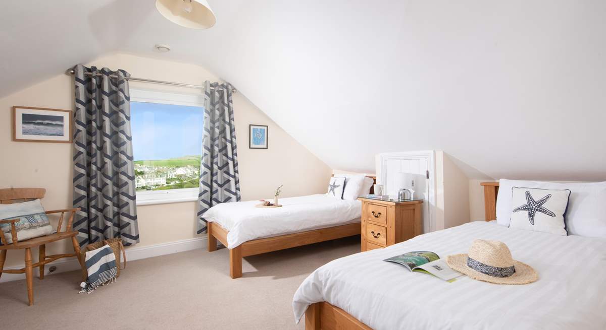 The modern first floor twin bedroom, with views of Port Isaac.