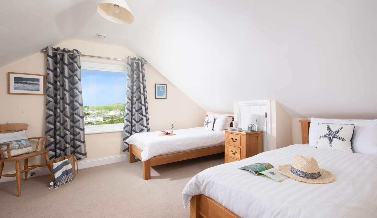 The modern first floor twin bedroom, with views of Port Isaac.