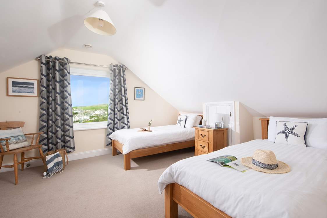 The modern first floor twin bedroom, with views of Port Isaac.