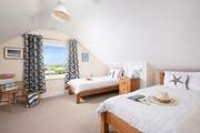 The modern first floor twin bedroom, with views of Port Isaac.
