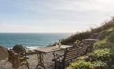 The steep terraced garden has spectacular views across the village and cove and is accessed via steep stone steps to the rear of the cottage. - Thumbnail Image