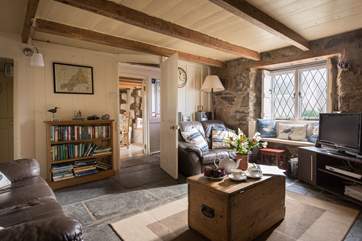 The sitting-room is opposite the dining-room, both of which are either side of the entrance hallway.