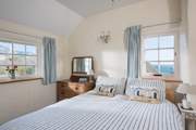 This bedroom has sea views, lie in bed and listen to the crashing waves.