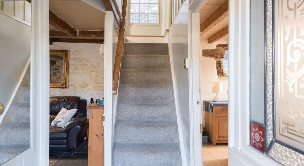 The cottage stairs lead to the family bathroom and three bedrooms.