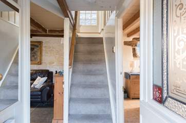 The cottage stairs lead to the family bathroom and three bedrooms.