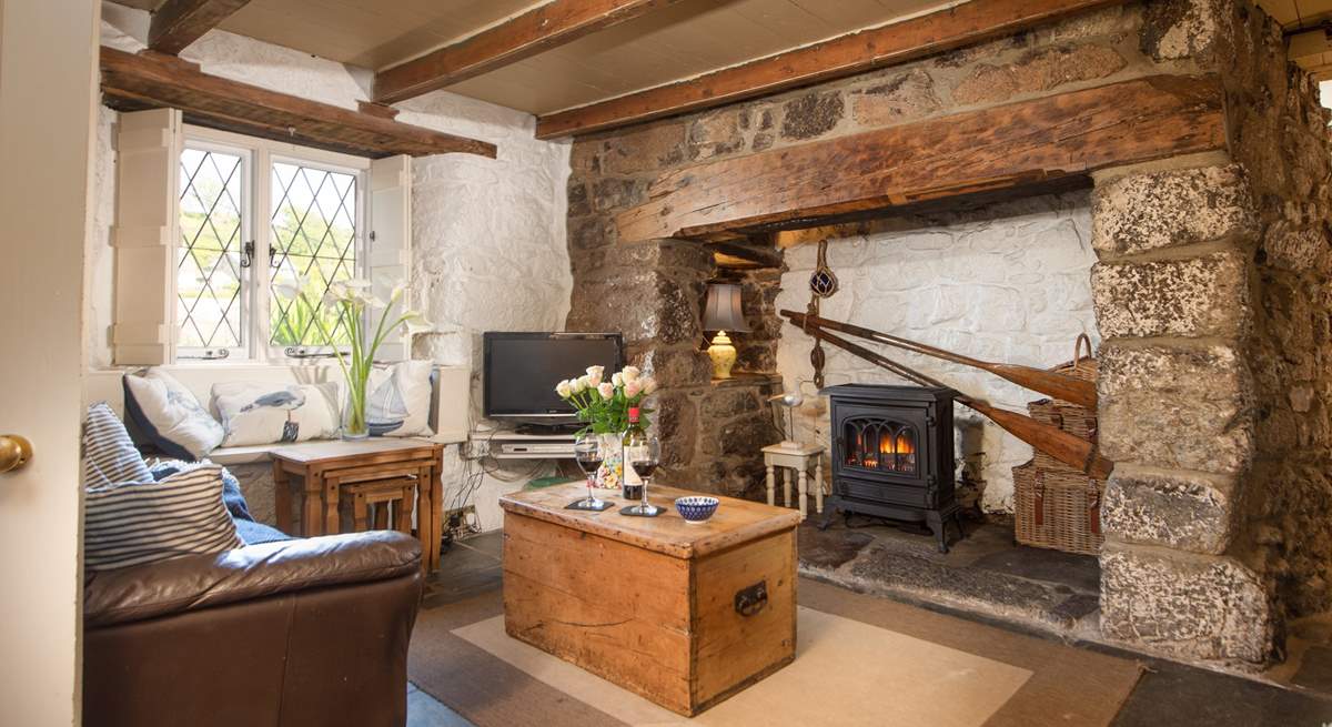 Room to relax with friends and family in the cottage sitting-room, with a cosy wood-burner effect electric stove.