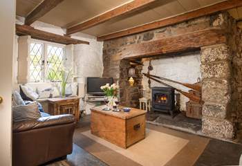 Room to relax with friends and family in the cottage sitting-room, with a cosy wood-burner effect electric stove.