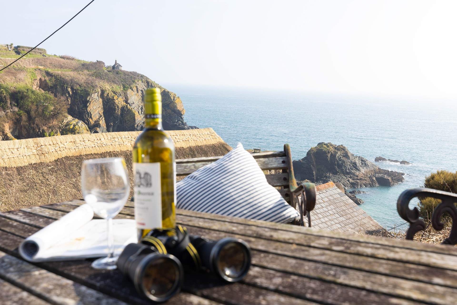 The steep terraced garden has spectacular views across the village and cove and is accessed via steep stone steps to the rear of the cottage.