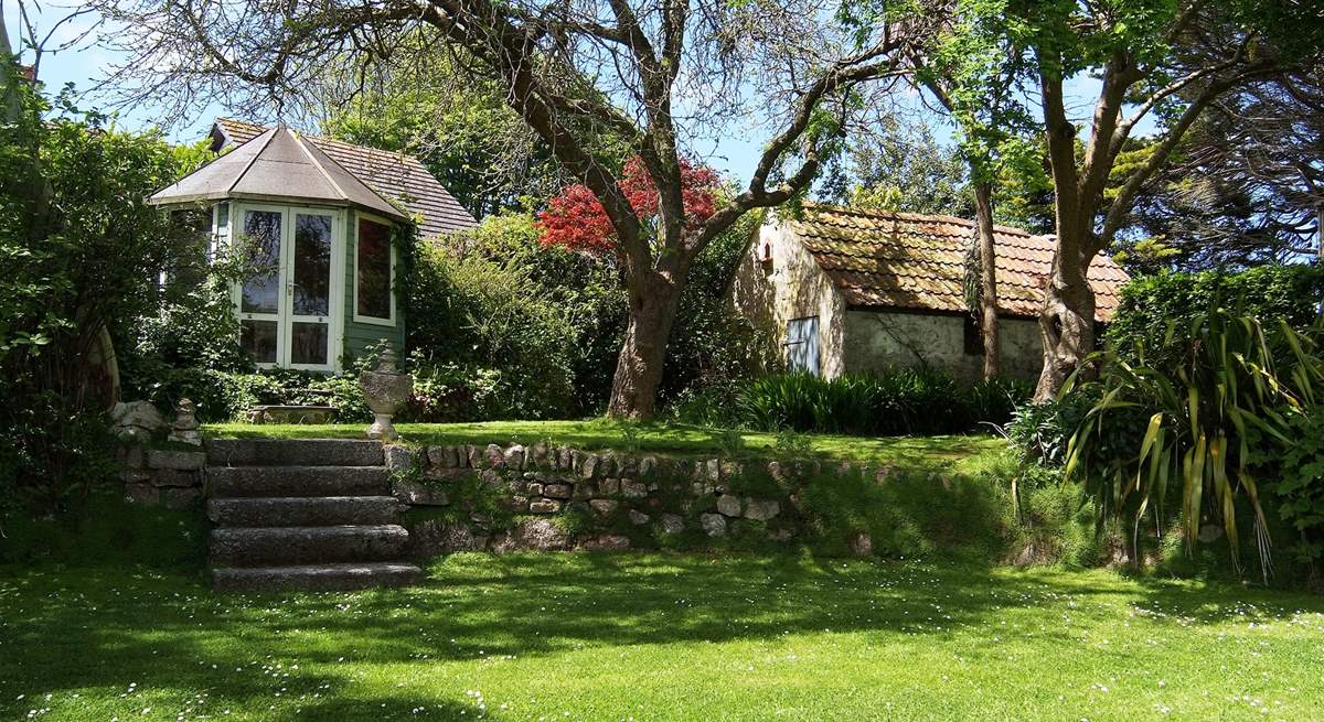 Steps lead up from the house to the lawn and summer-house.