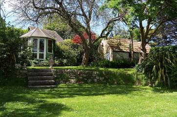 Steps lead up from the house to the lawn and summer-house.