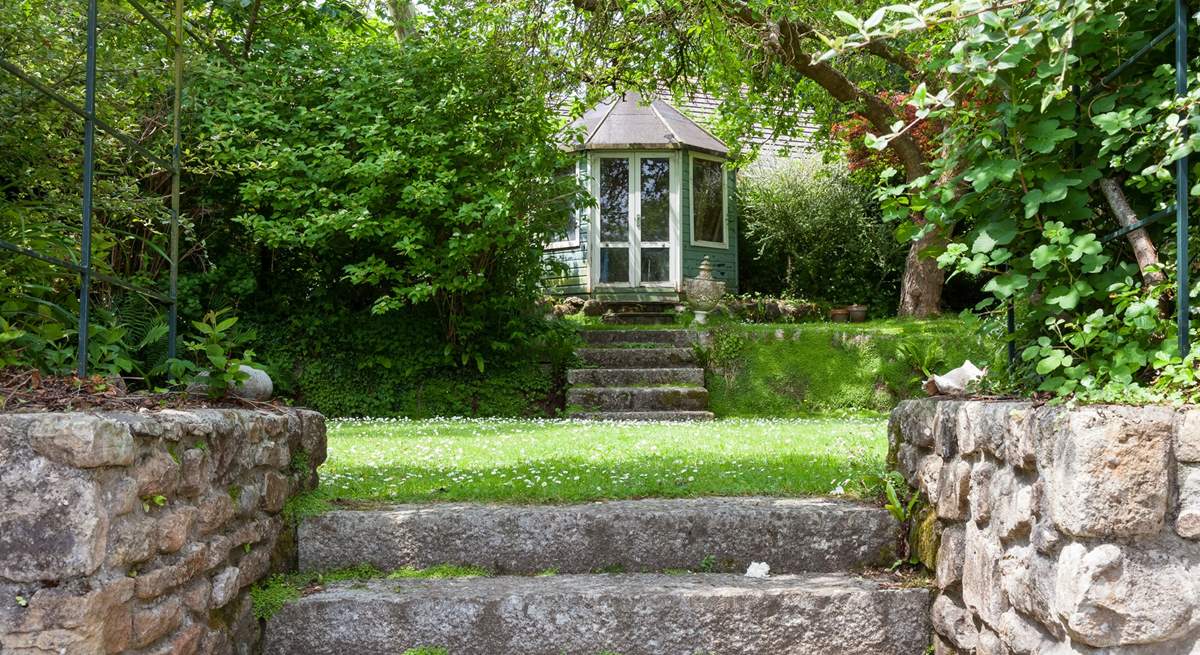 The beautiful garden is full of green leaves and both sunny and shady spots for holiday relaxing.