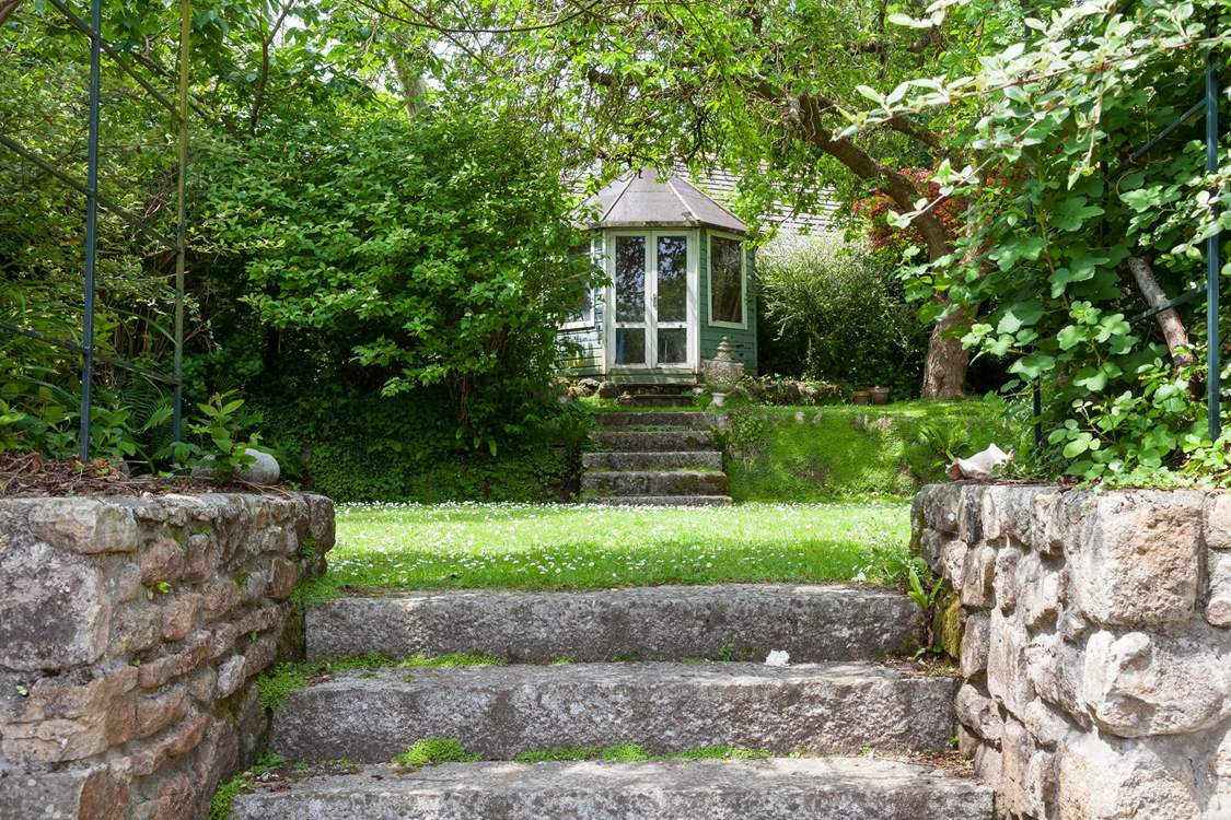 The beautiful garden is full of green leaves and both sunny and shady spots for holiday relaxing.