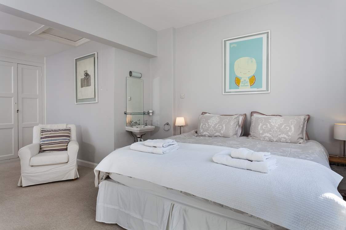 Bedroom 2 has 'zip and link' beds and a wash-basin.