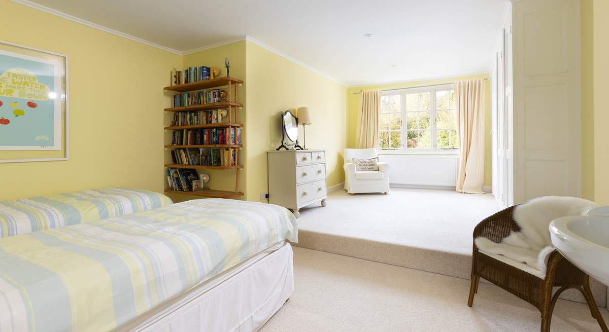 Spacious bedroom 3 with super lovely armchair by the window where you can snuggle up with a good book or simply stare out to the garden and day dream. 