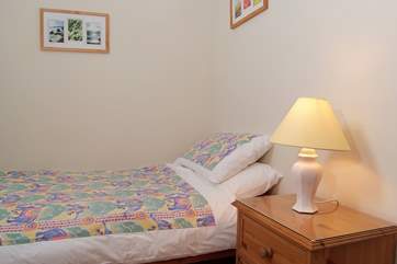 The pretty single bedroom - a Velux window brightens the room.