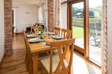 The dining-area has French doors that open onto the patio and fully enclosed garden. The solid oak table and chairs comfortably seat up to six guests.