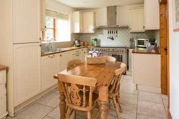 The well-equipped kitchen has a welcoming farmhouse-style table where on arrival you will find a hamper full of delicious local produce.