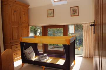 There is a dedicated cot room with a standard cot sized travel cot and plenty of storage space. For afternoon naps the velux window has a blackout blind.