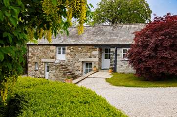 The front of the cottage which has a front door on the lower as well as the upper level - with the annexe on the right.