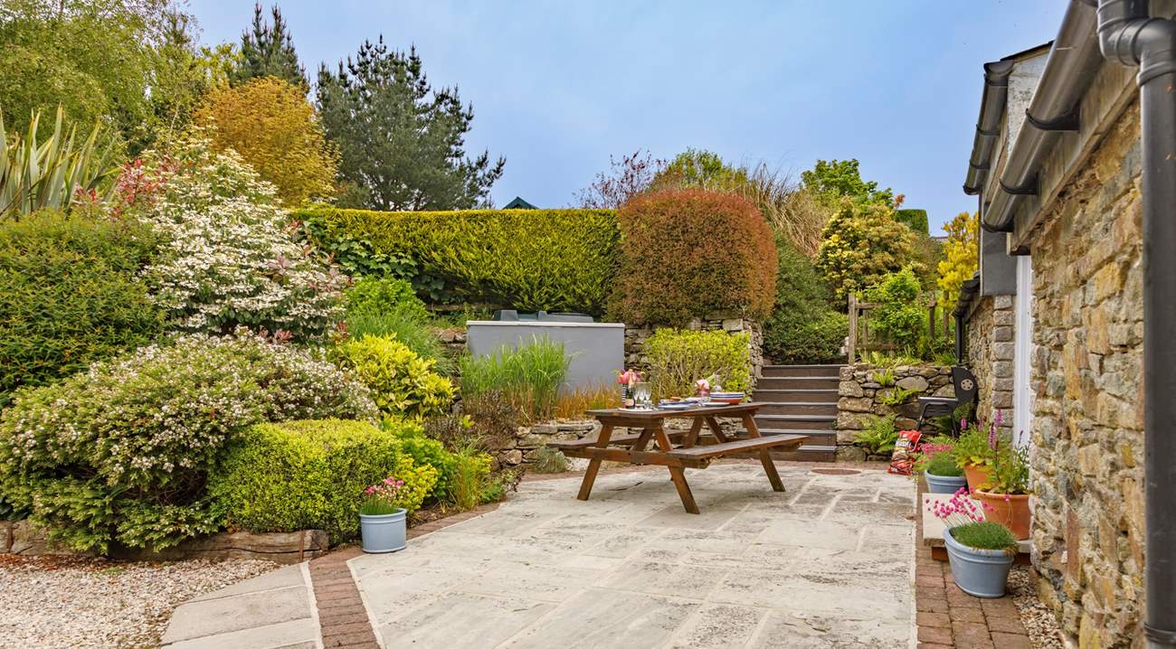 At the rear of the cottage there is a sunny patio-area and huge shared garden to play in - you won't want to leave.