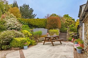 At the rear of the cottage there is a sunny patio-area and huge shared garden to play in - you won't want to leave.