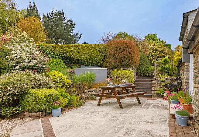 At the rear of the cottage there is a sunny patio-area and huge shared garden to play in - you won't want to leave.