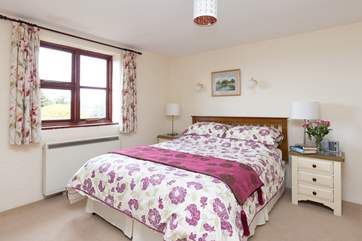 The master bedroom looks out over the countryside right across the valley.