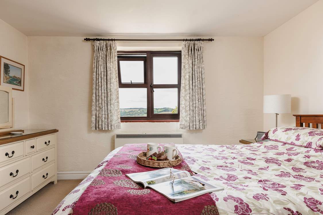 The master bedroom looks out over the countryside right across the valley.