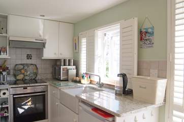 The kitchen-area is compact but very well-equipped and pale granite worksurfaces reflect lots of light.