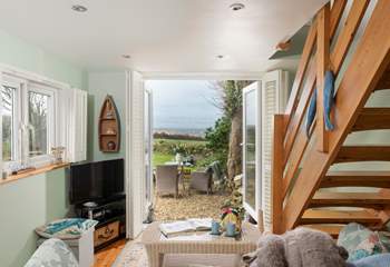 Double doors open to the large garden with sea views. 