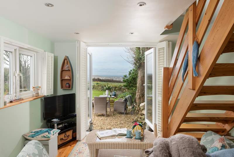 Double doors open to the large garden with sea views. 