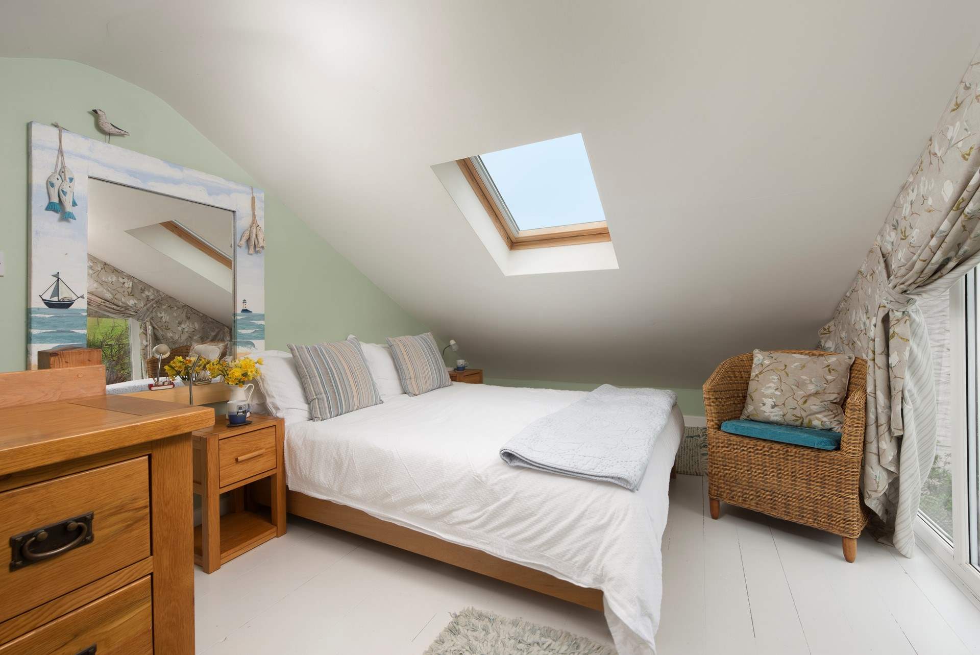 The cosy double bed is tucked into the eaves for a good nights sleep. 