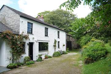 The cottage is in a beautiful tree-lined setting.