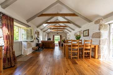 Open-plan, reverse living with a wood-burner at the heart of the room.