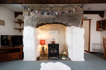 The cottage has a beautiful ornamental fireplace.