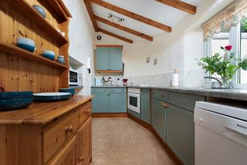 The kitchen overlooks the pretty patio and garden-area.