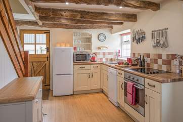 The kitchen is tucked at one end of the open plan ground floor living-area.