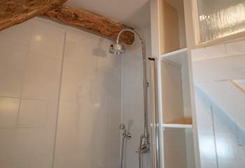 The shower is positioned over the bath with two attachments.
