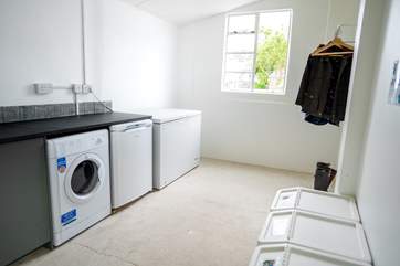 Across the courtyard there is a utility room for storing your body boards or hanging up coats and storing muddy boots.
