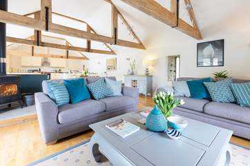 The sitting-room at the opposite end of the the first floor galleried-area, with a wood-burner for cosy evenings together.