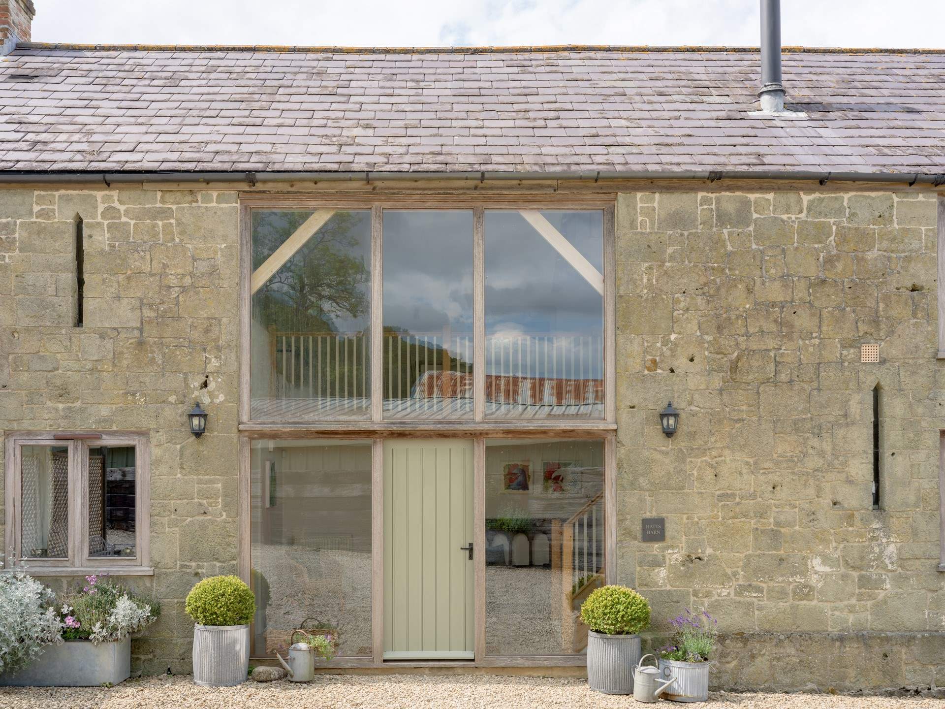 The impressive facade and curated planting makes the barn and lovely sight to see.