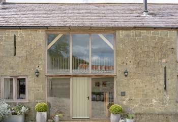 The impressive facade and curated planting makes the barn and lovely sight to see.