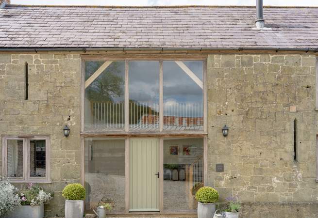 The impressive facade and curated planting makes the barn and lovely sight to see.